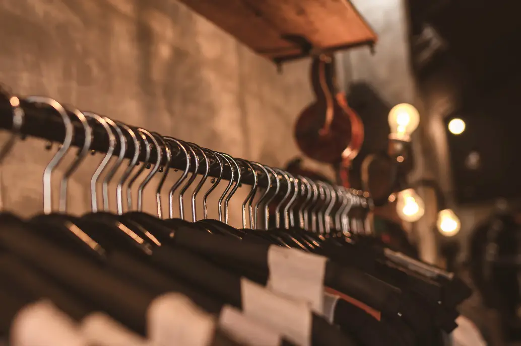 Photo of Black Clothes on Hangers